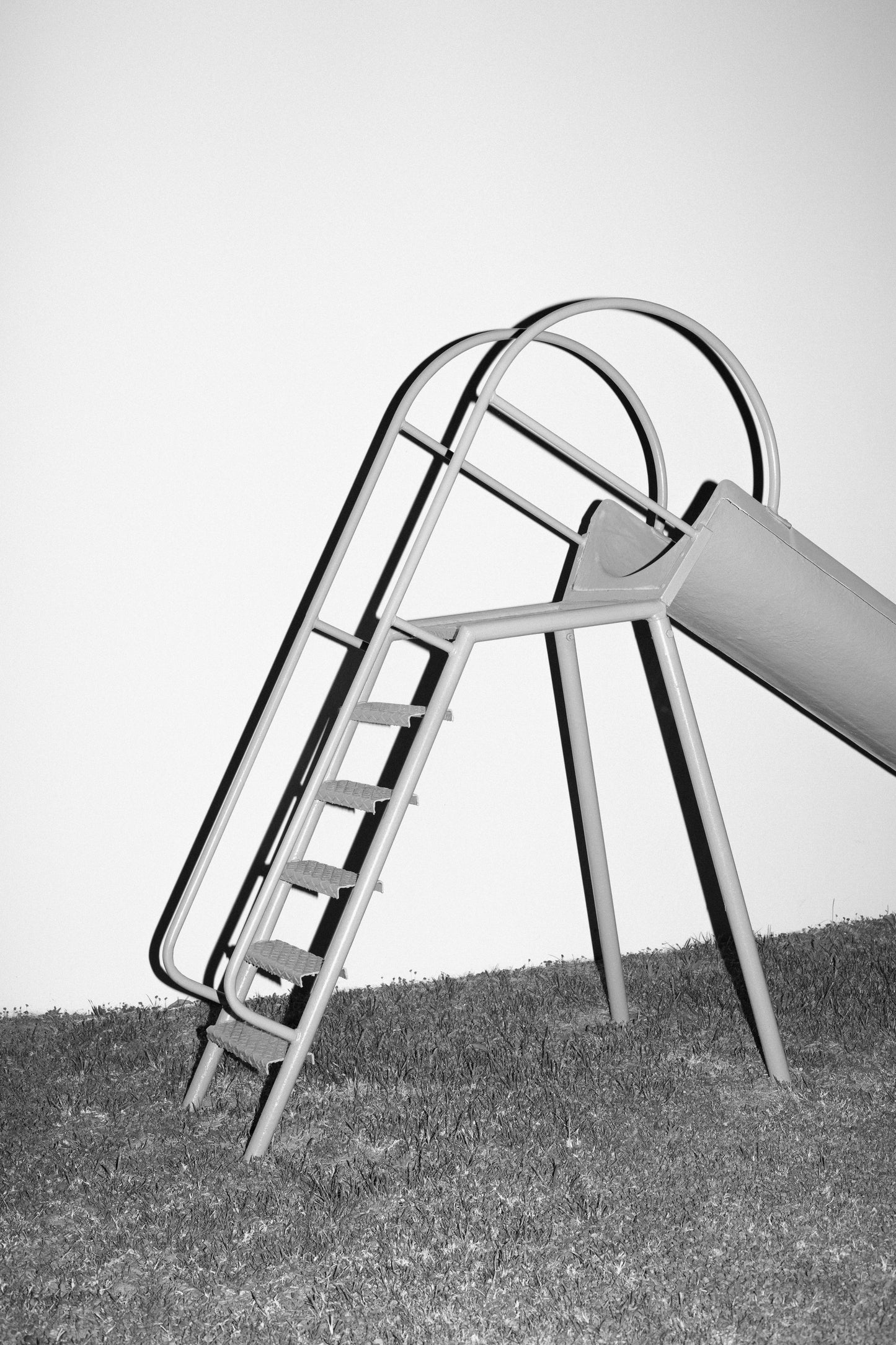 Playground slide with ladder on a grassy area
