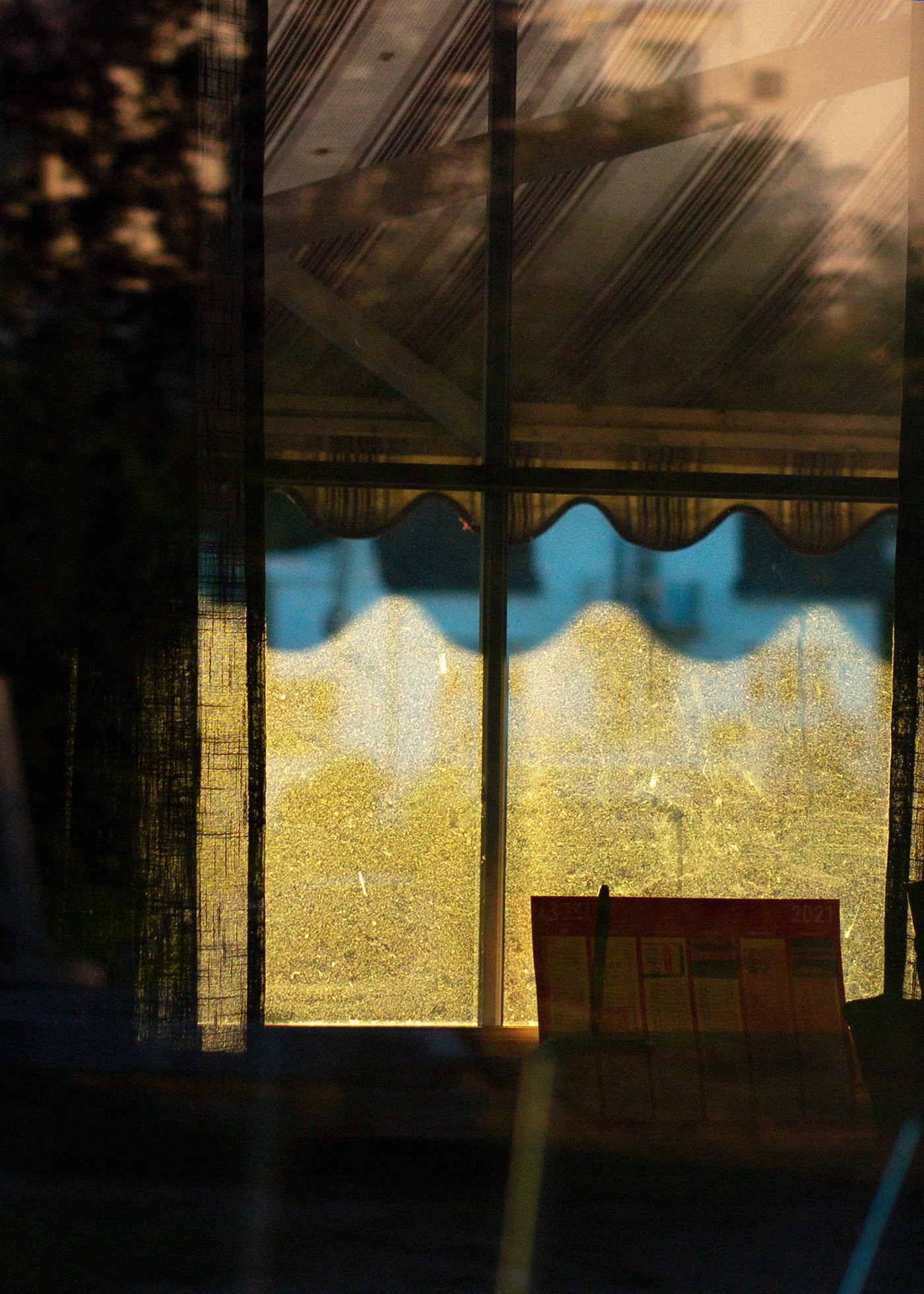 Reflective surface showing a building's reflection with a blurred background