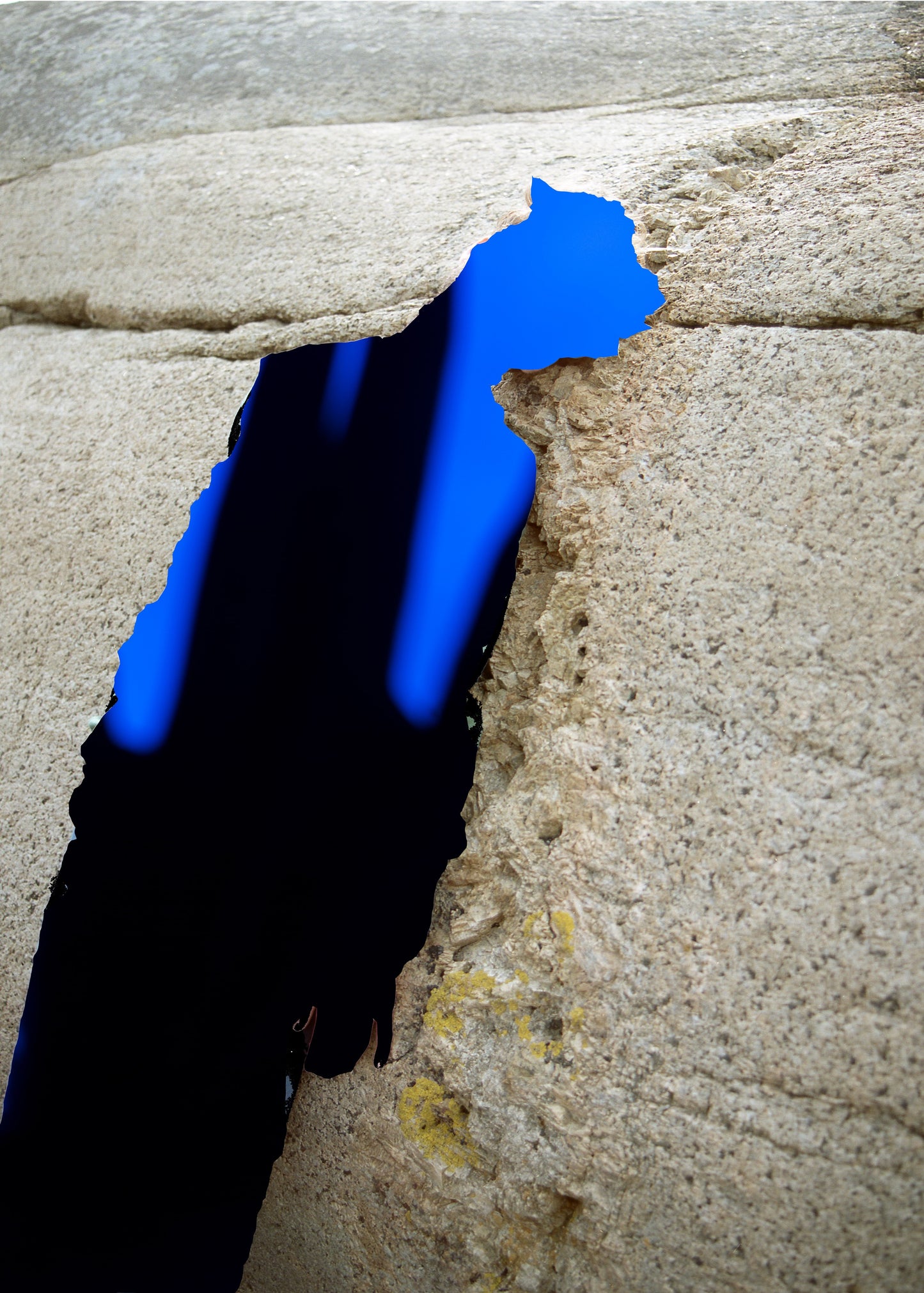 Blue handprint on a stone wall