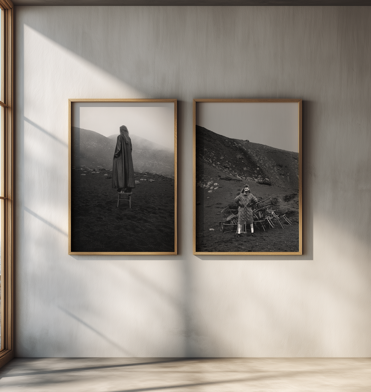 Two framed black and white photographs by Dusan Reljin of a person in a landscape on a wall.