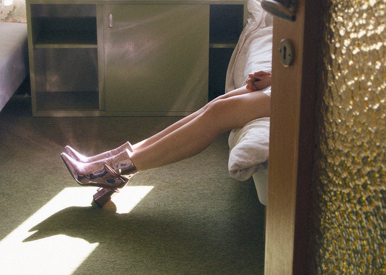 A poster featuring a photograph by Julie Pike, depicting a person in a reflective space with a dreamy expression.