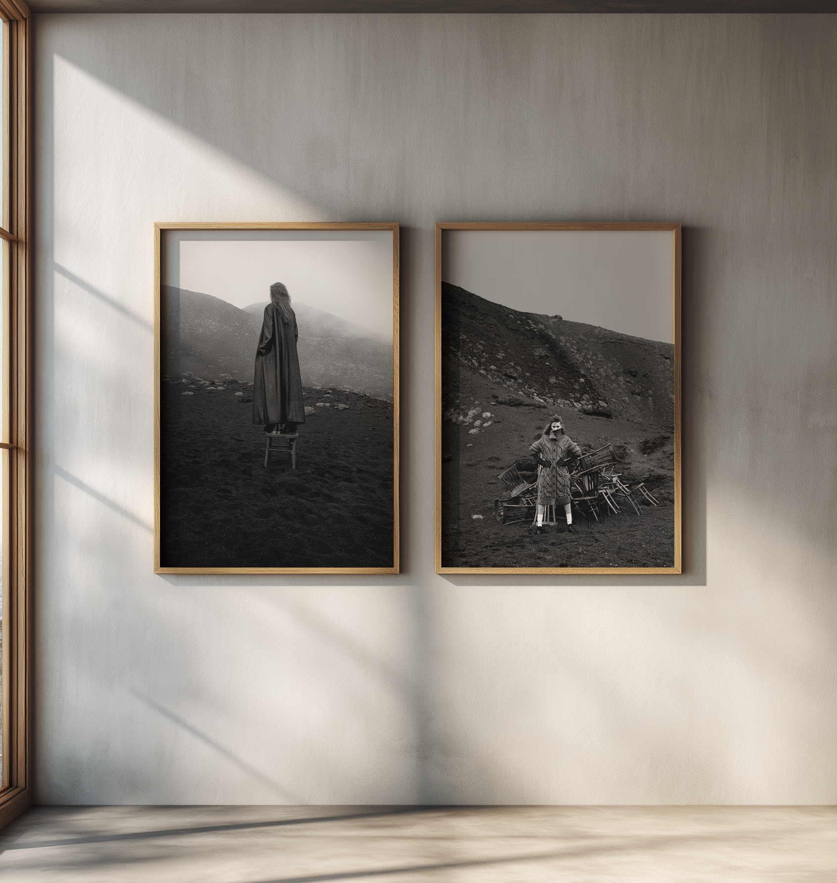 Two framed black and white photographs by Dusan Reljin of a person in a landscape on a wall. 
