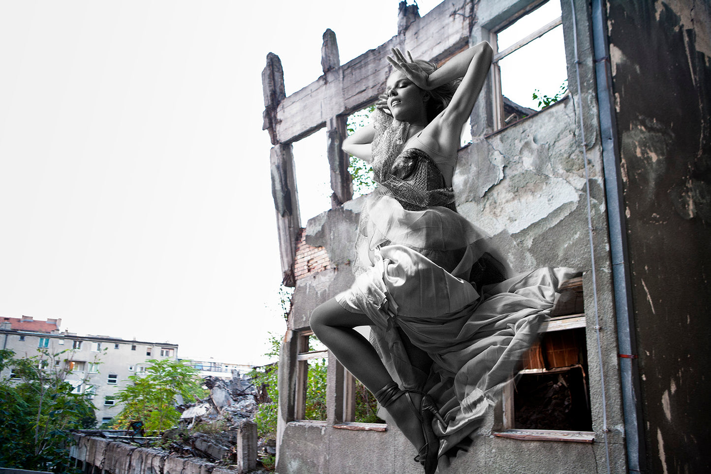 A black and white photograph of a person climbing a structure, capturing an urban artistic expression.